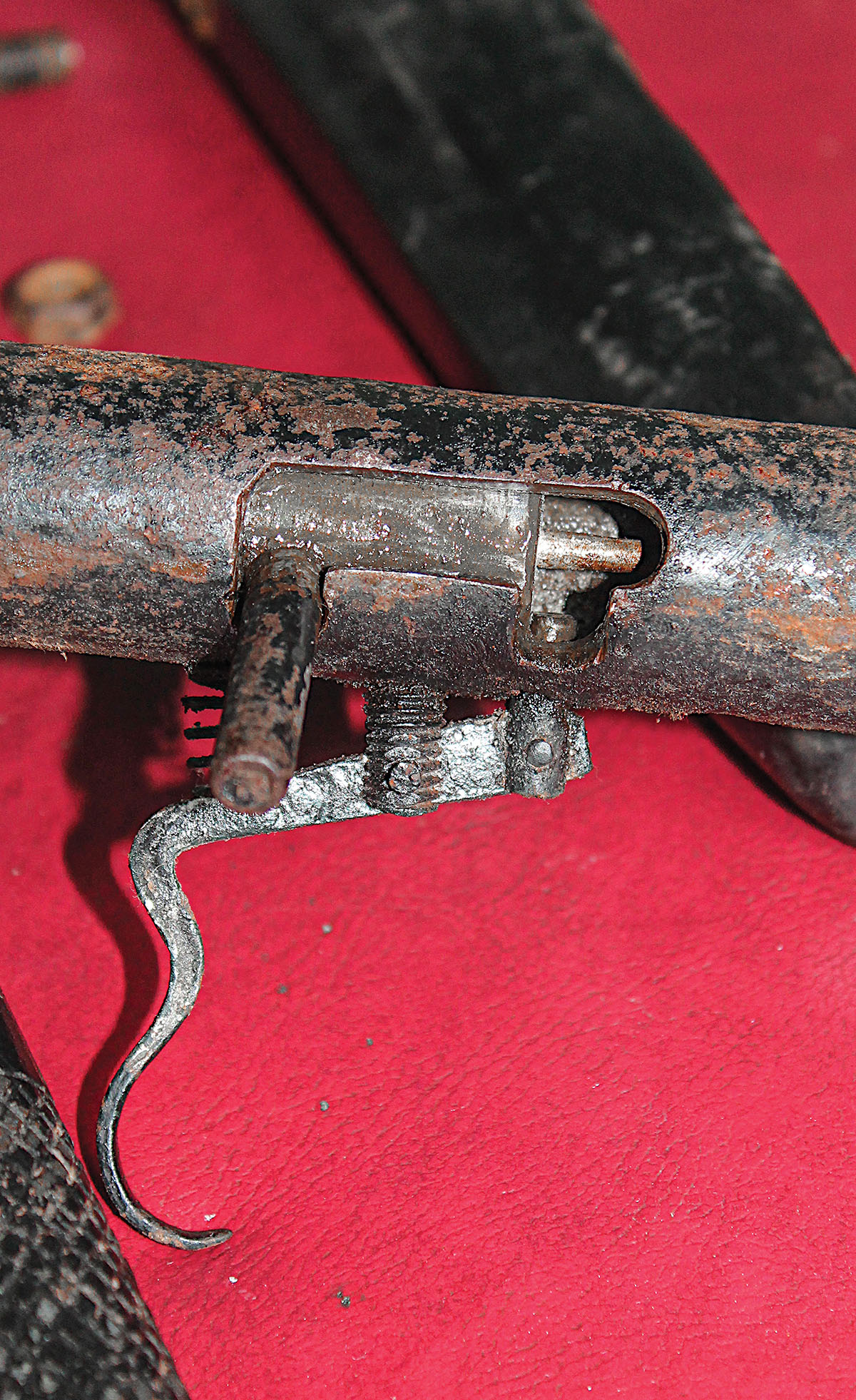The action is shown here in its cocked and “on safe” position, the “sear” tip visible engaging the bolt face. The questions were whether it was too rusty to work, and if it did, would the shotgun hold together?